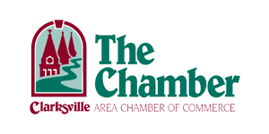 Logo for the Clarksville Area Chamber of Commerce. It features an arched design with three spires, a winding path, and the text "The Chamber" in green. Below, it says "Clarksville Area Chamber of Commerce" in red. from Higley Construction